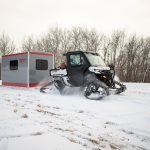 Different ways to transport a skid house - skid house transported on the ice with an ATV