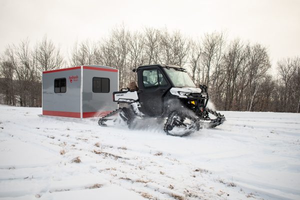 Different ways to transport a skid house - skid house transported on the ice with an ATV