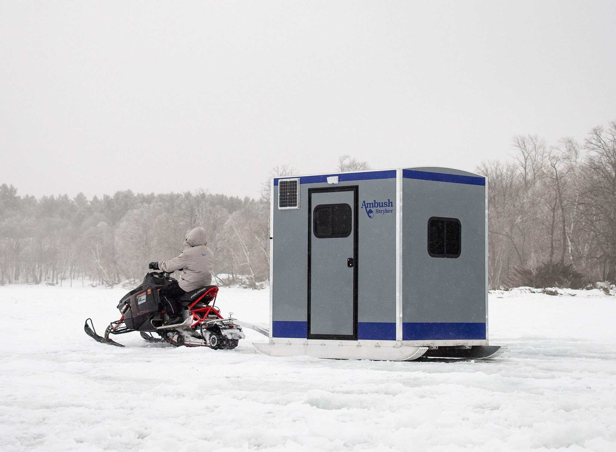 Transport a skid house with a snowmobile