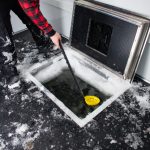 scooping out ice from skid house dark house